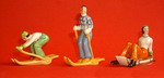Figurines of females skiing and sledging